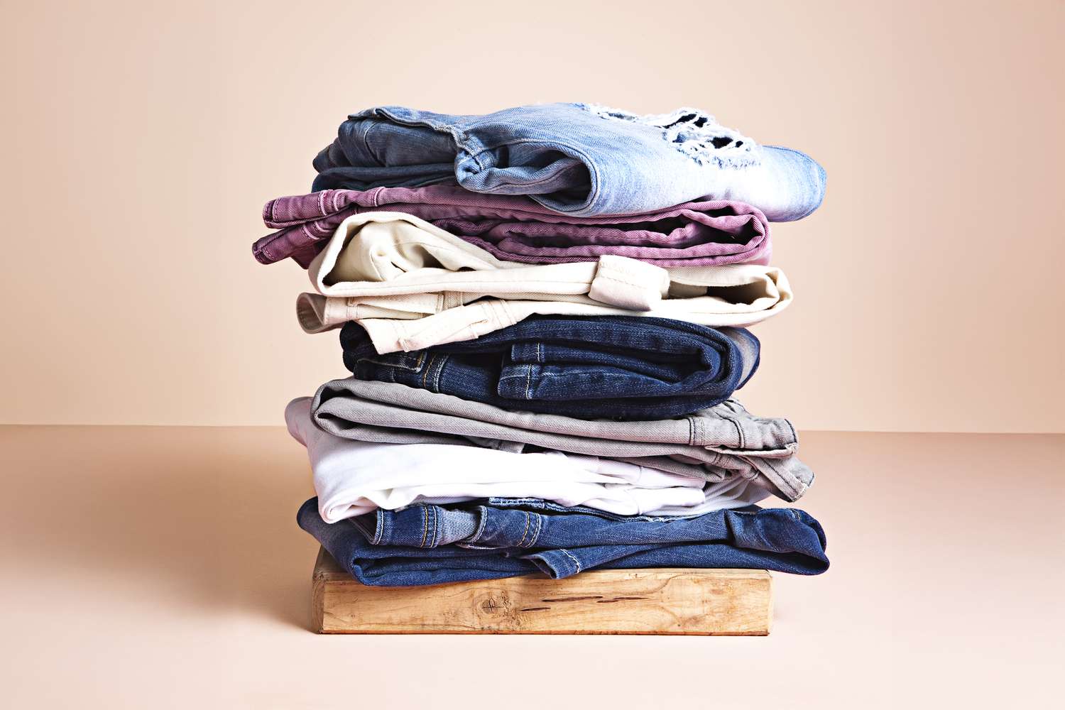 Neatly folded laundry stacked on a wooden crate